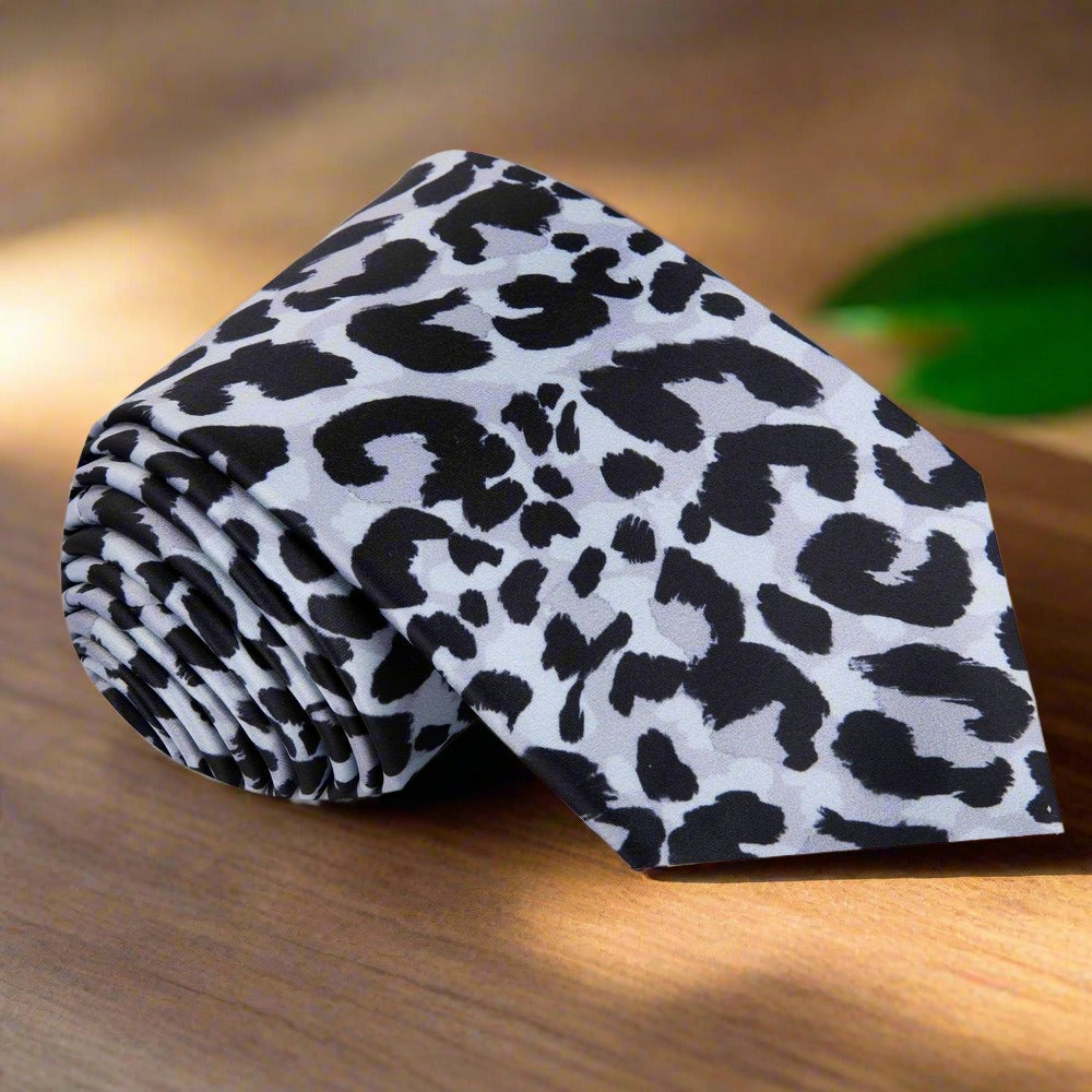 Model showcasing a bold cheetah print silk necktie with a dark suit