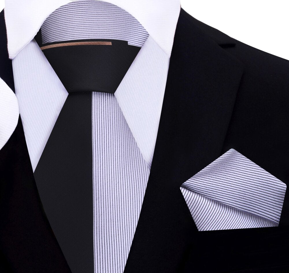 The two-toned silk necktie paired with a crisp white shirt, perfect for business.