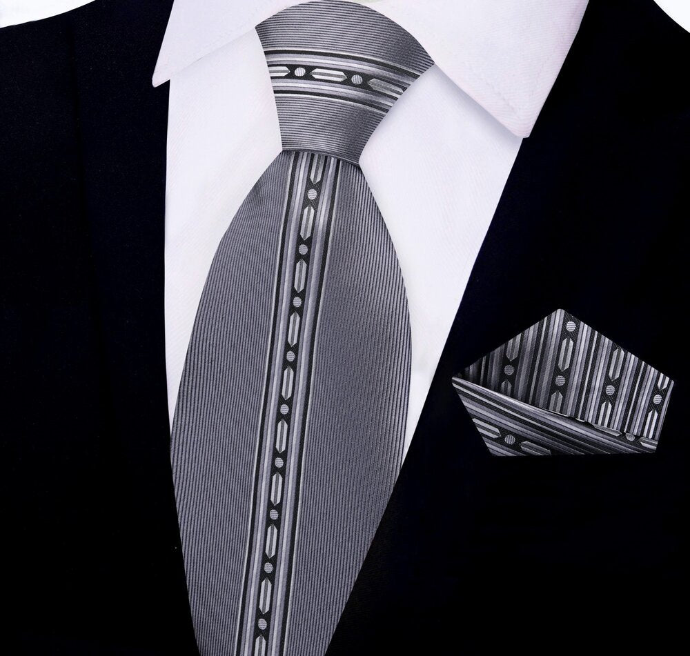 Close-up of the silk tie showing black, red, and grey linked stripe pattern—ideal for formal wear.