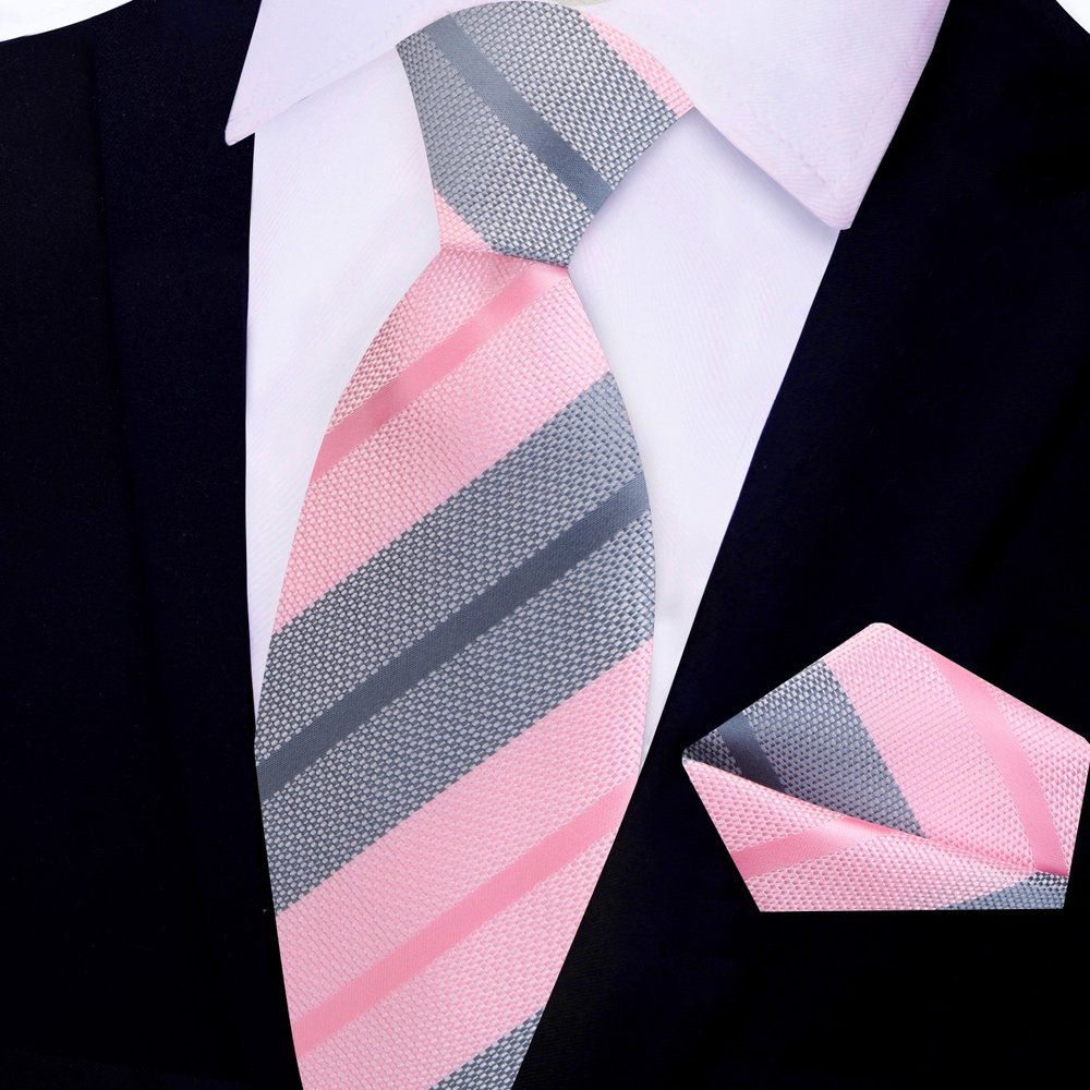 Stylish Pink and Grey Striped Silk Necktie paired with a navy blue suit at a wedding.