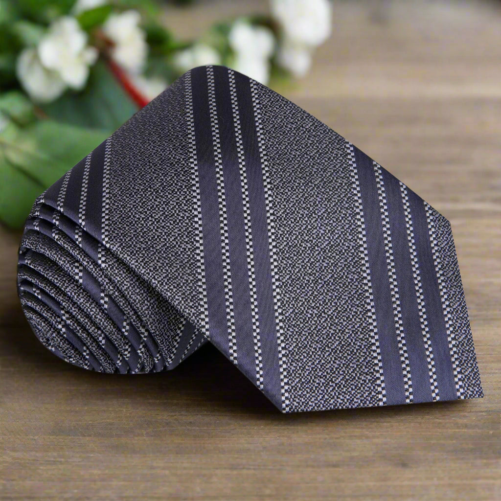 Elegant steel grey silk necktie on a wooden table, showcasing its refined design for formal wear.