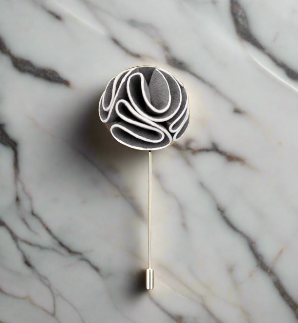 Elegant custom flower lapel pin displayed on a suit jacket.
