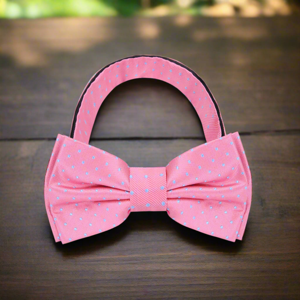 Close-up of pink and light blue polka dot silk bow tie with vibrant pattern