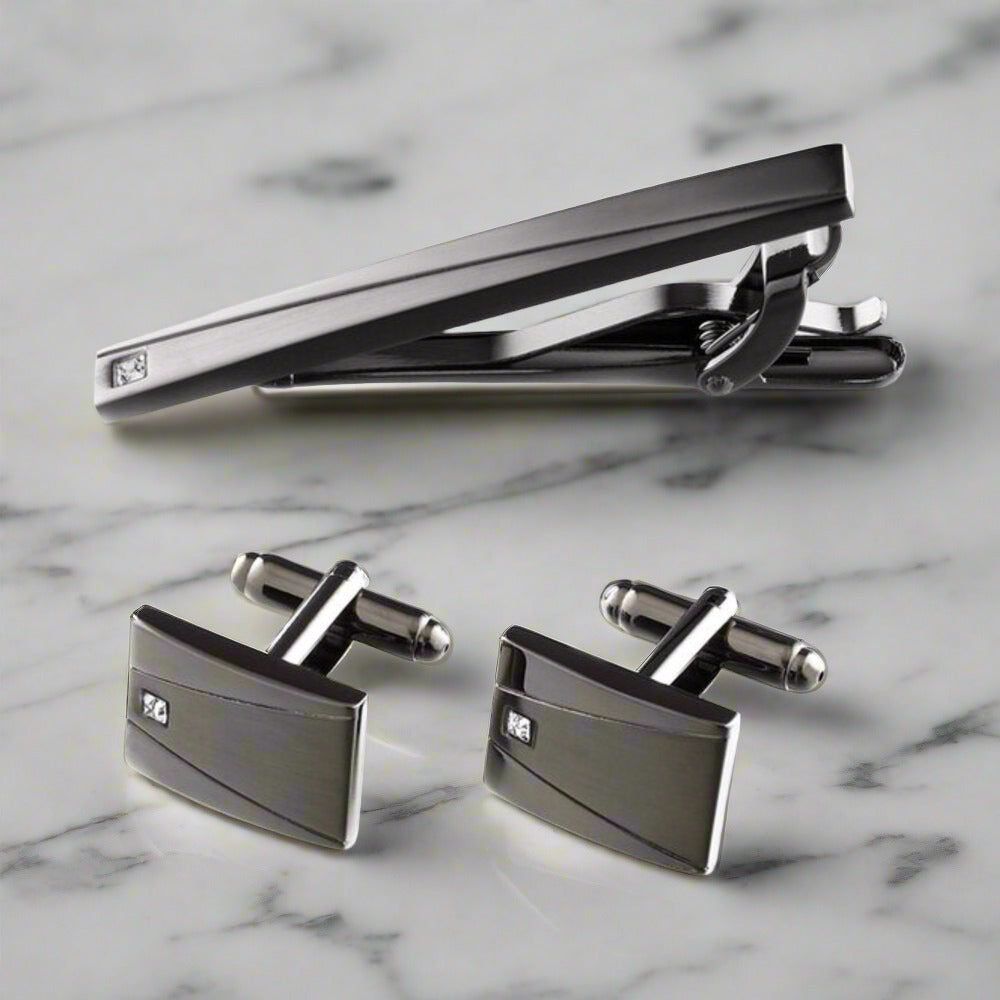 Gun metal tie bar and cufflinks set showcased on a formal shirt.