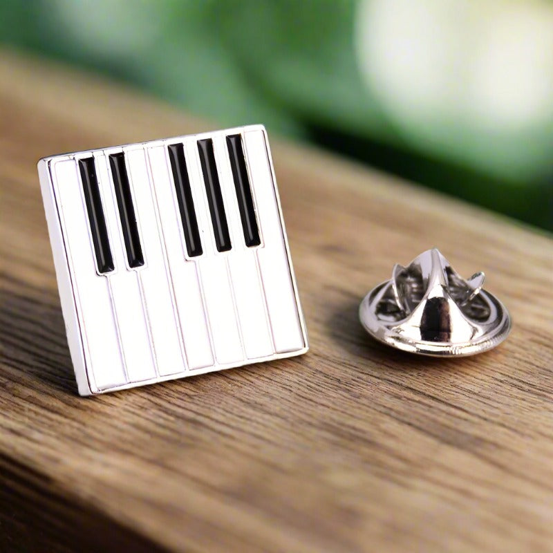 Close-up angle of music lapel pin showing treble clef and drum detailing — perfect as a treble clef pin for music teachers.