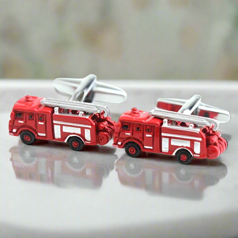 Close-up of red fire truck cufflinks on a white shirt