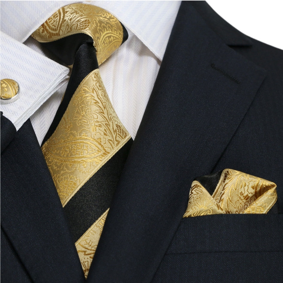 Close-up of luxurious silk paisley necktie in gold and black for formal events