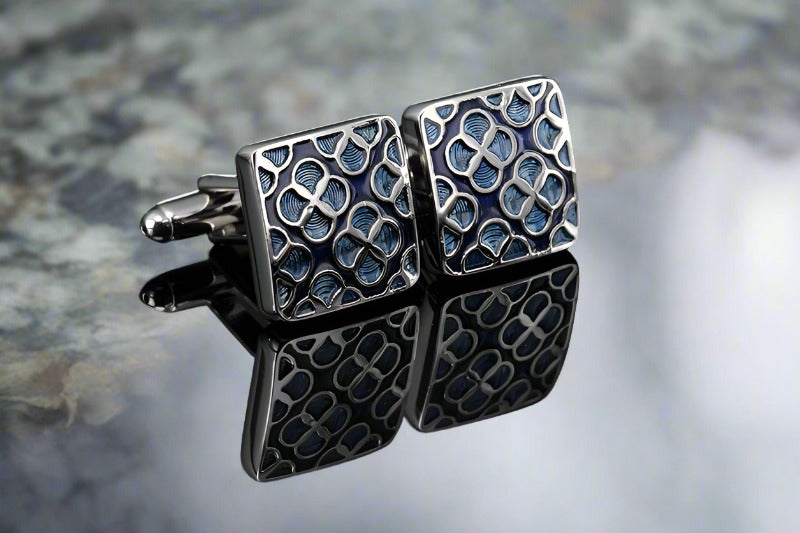 Close-up of intricate silver cufflinks with geometric design for formal occasions