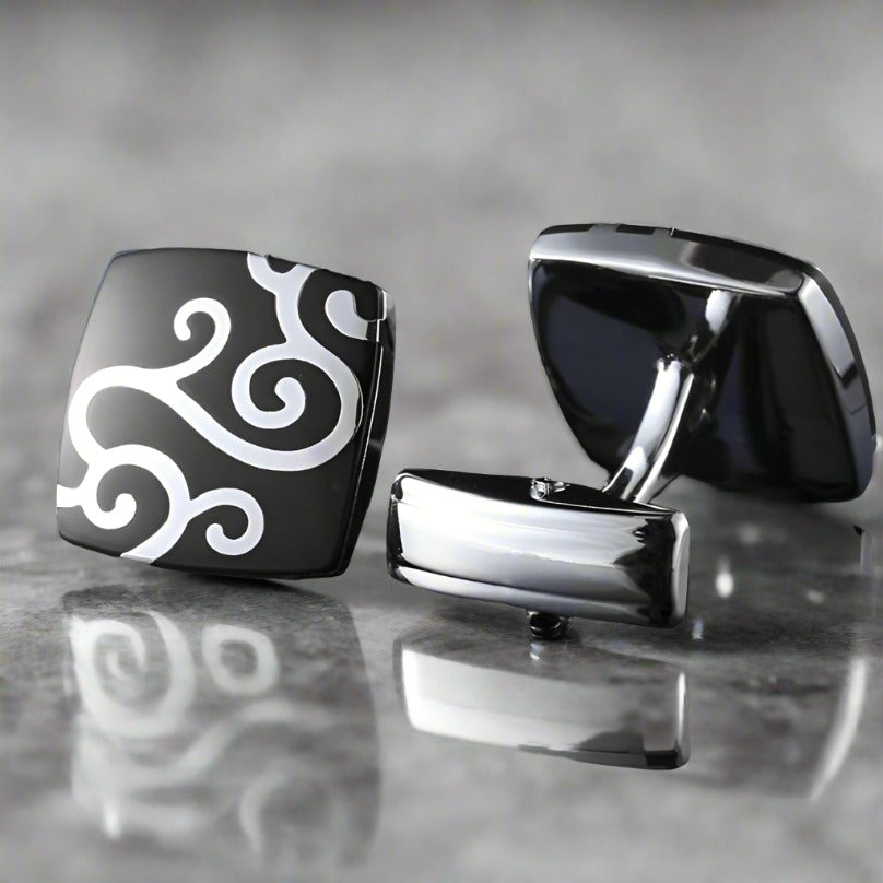 Square chrome cufflinks with black and white vine pattern on a formal shirt