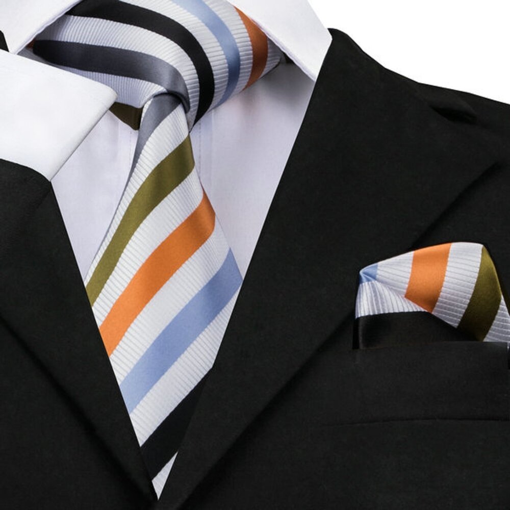 Young boy adjusting his boys silk tie for formal event