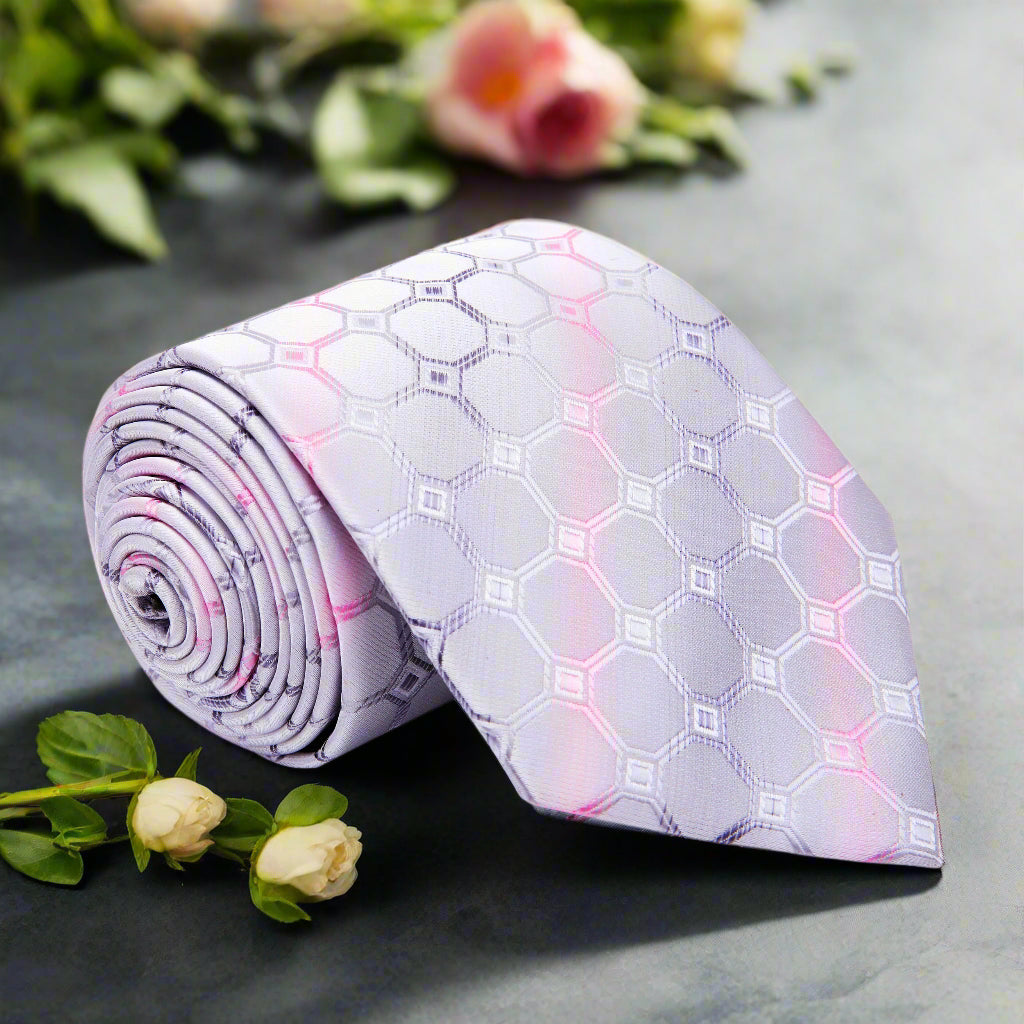 Close-up of elegant silver and pink geometric silk tie highlighting the intricate pattern.