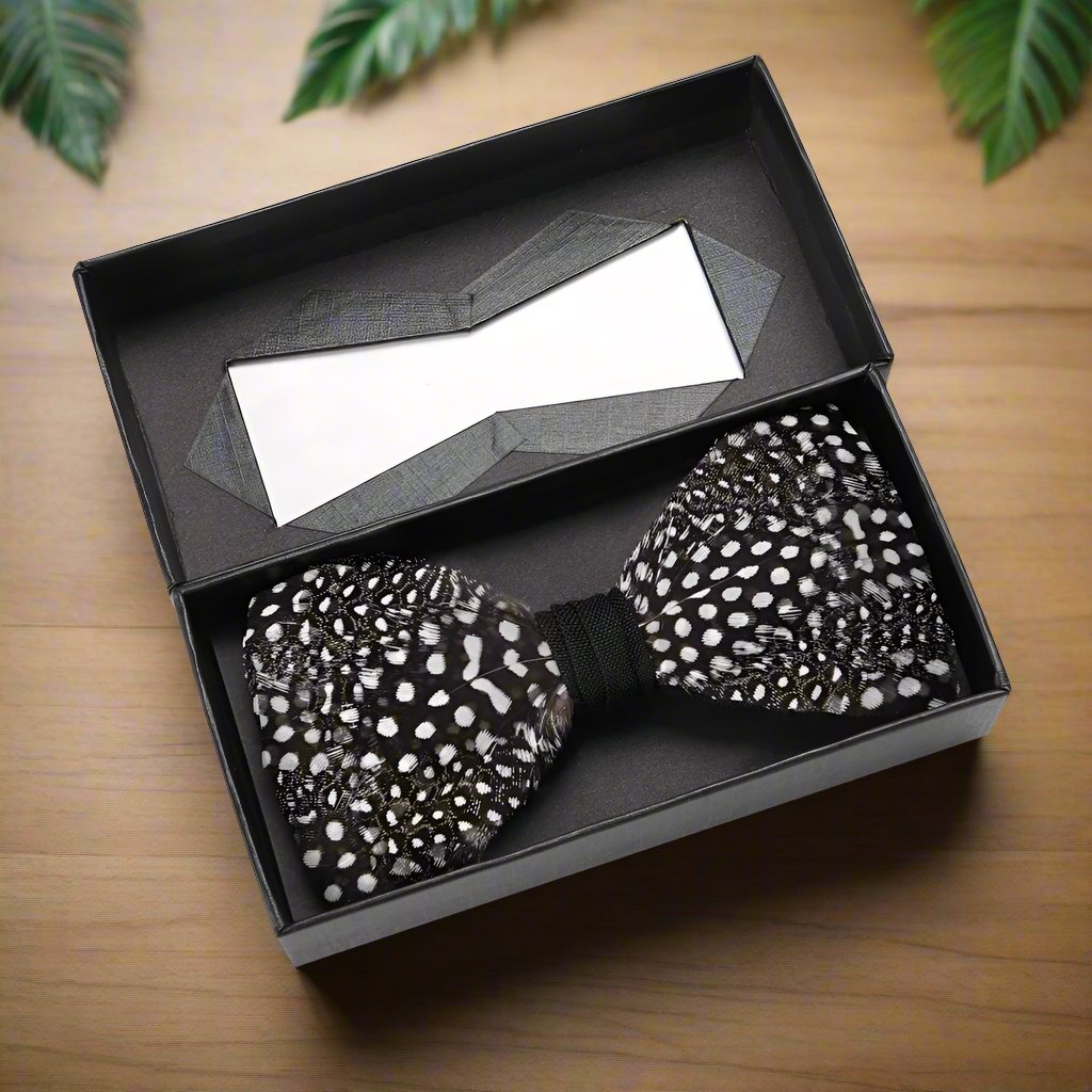 Black, white, and brown feather bow tie with dotted pattern on a model
