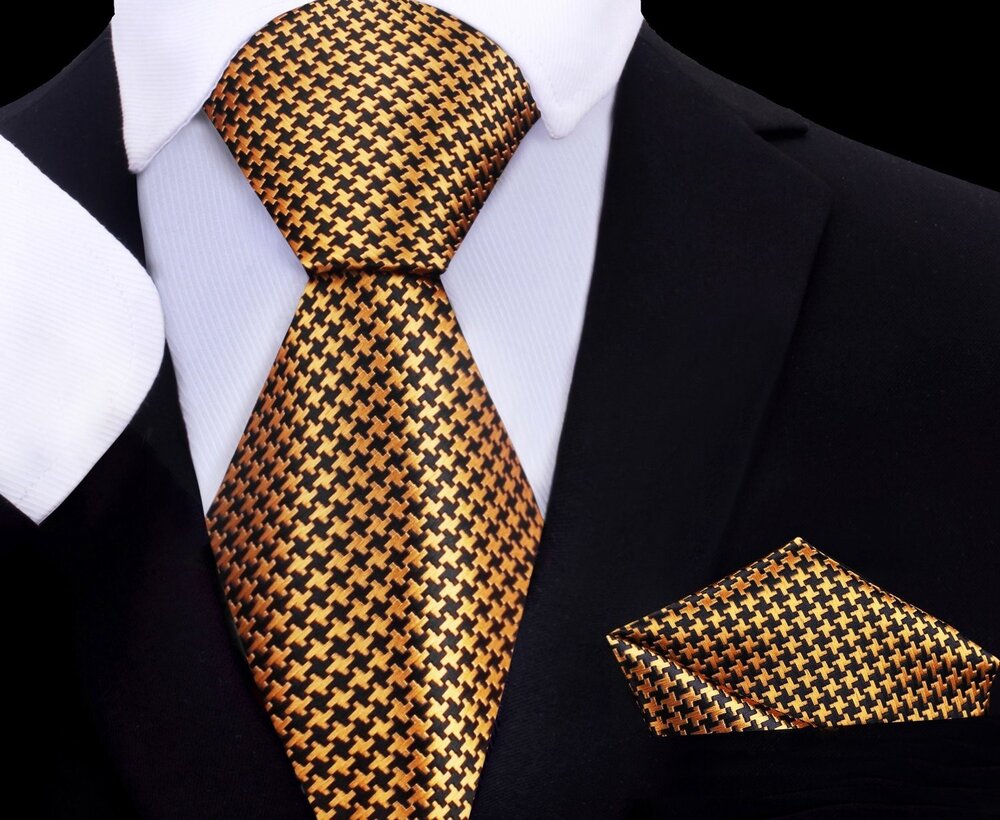 Close-up of kids gold and black silk necktie with geometric pattern