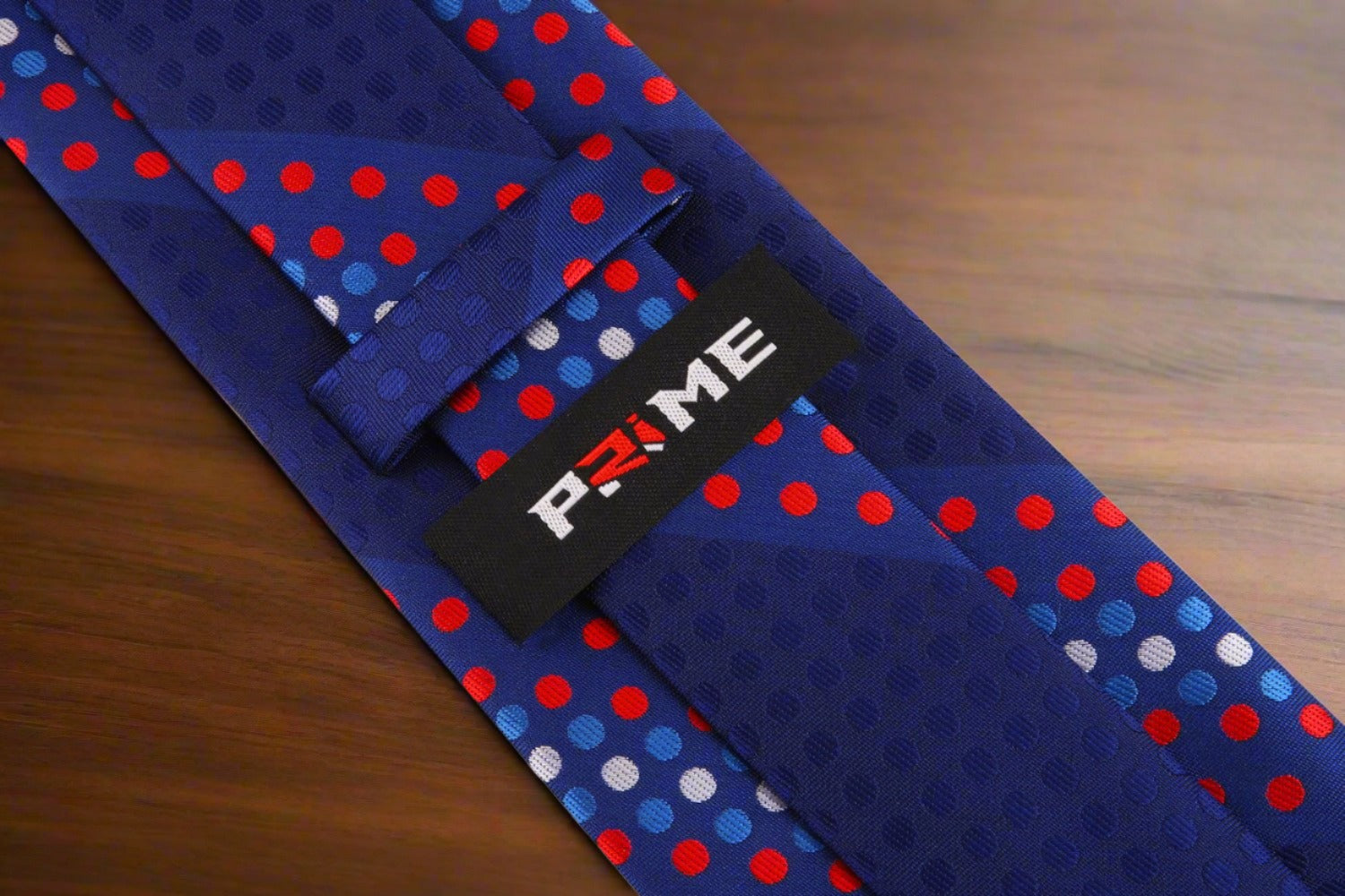 Front view of stylish polka dot silk tie in red and blue for men