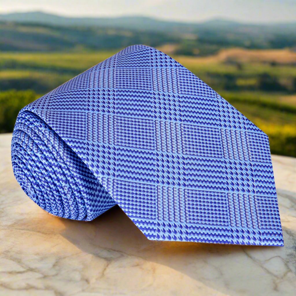 Men's silk necktie with plaid and houndstooth patterns in shades of blue, ideal for weddings and business events