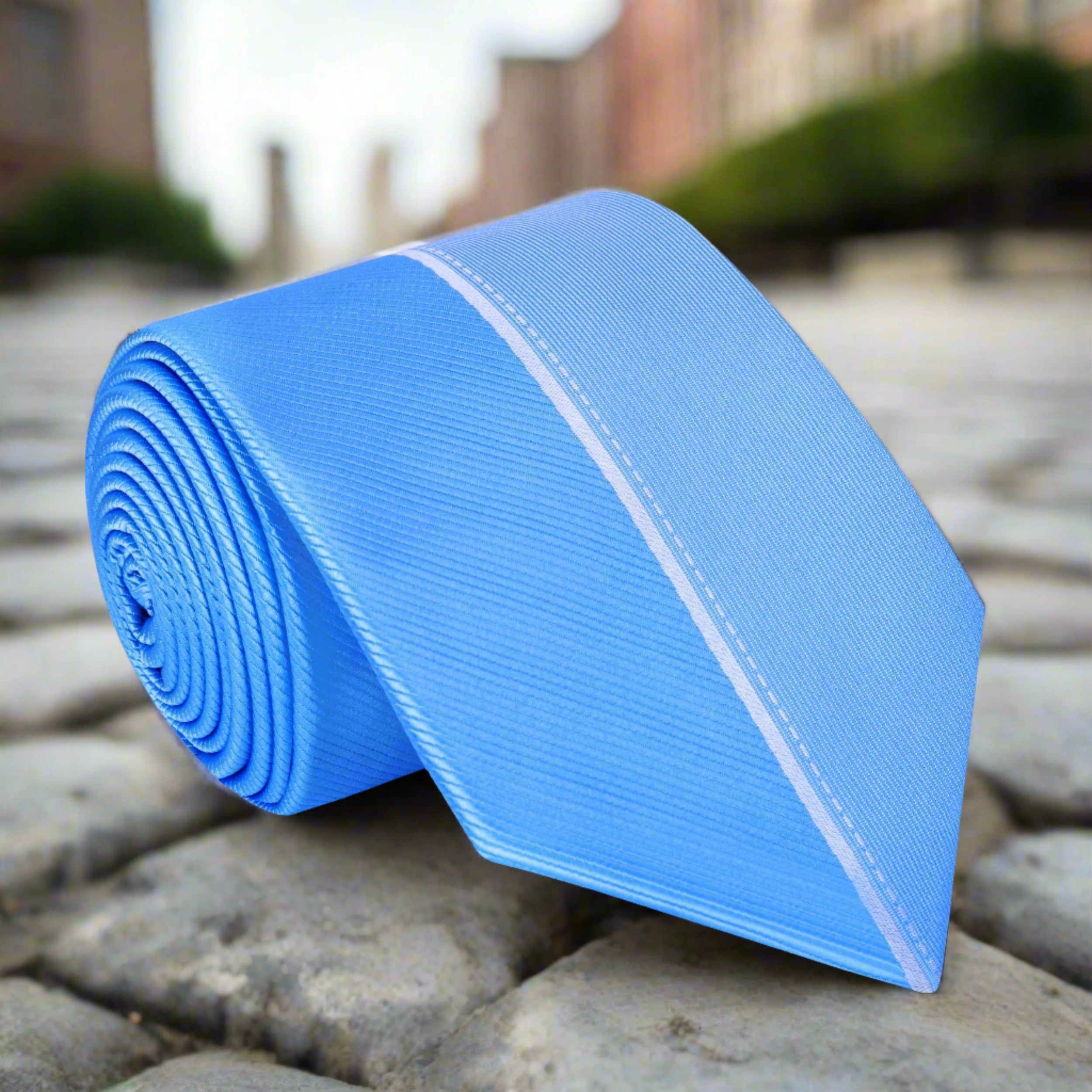 Close-up of light blue silk tie with white stripe for formal wear