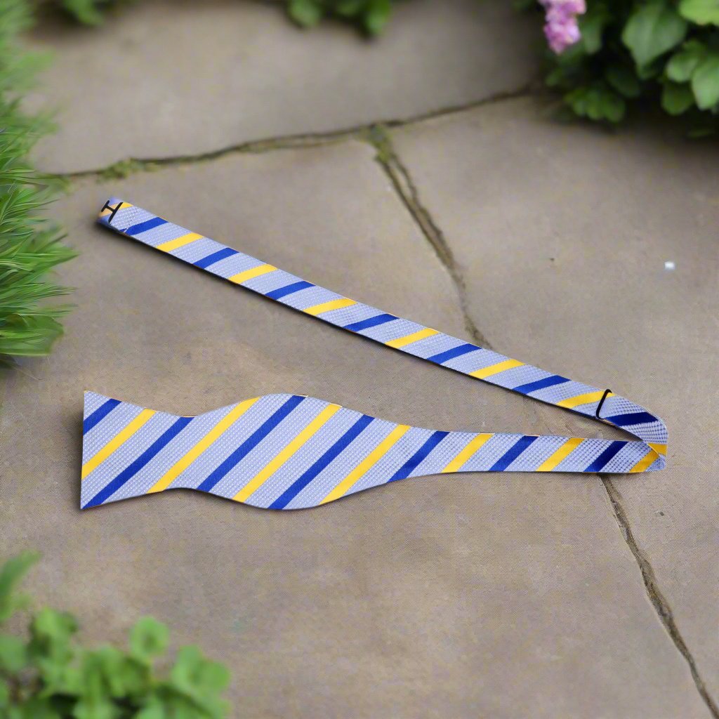 Elegant light blue silk self-tie bow tie displayed on a white shirt, showcasing its vibrant stripes.