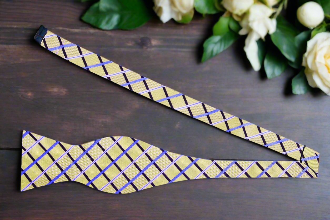 Elegant Light Gold and Blue Plaid Self-Tie Bow Tie displayed on a wooden table