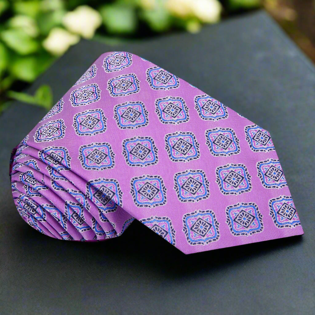 Close-up of the geometric medallion pattern on light purple and blue silk tie