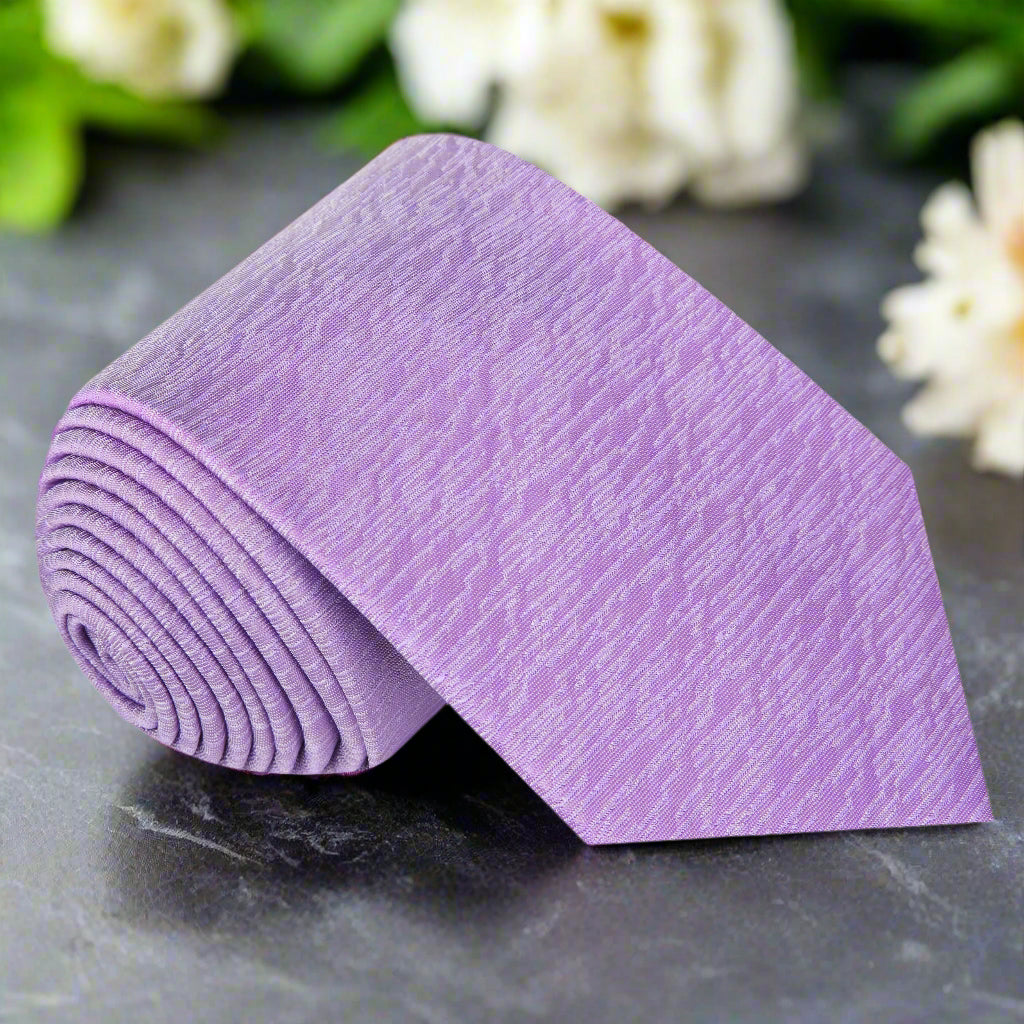 Elegant textured purple silk necktie displayed on a mannequin for formal wear