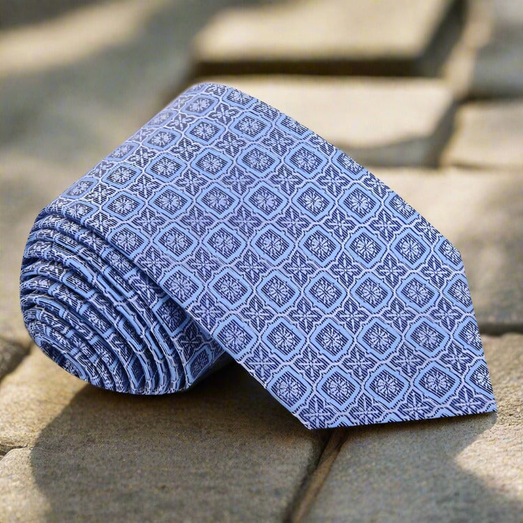 Close-up of peach geometric silk tie showcasing its luxurious fabric and pattern.