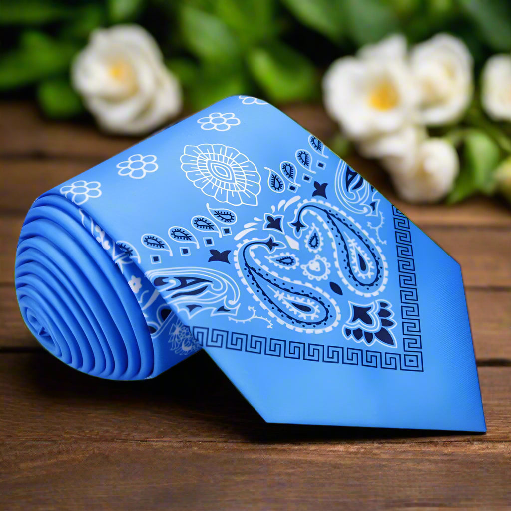 Elegant baby blue paisley silk tie draped over a shirt collar, perfect for weddings