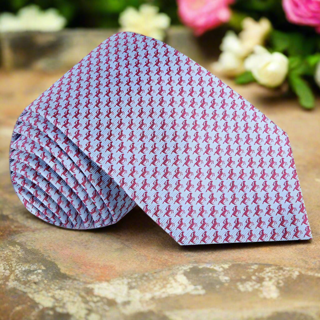 Close-up of the horse pattern silk necktie showcasing vibrant blue and red colors.