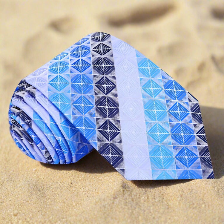 Close-up of a men's geometric silk tie in shades of brown and blue, showing detailed pattern and luxurious fabric.