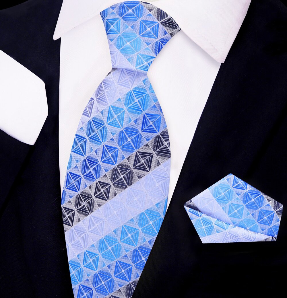 Close-up of a mens geometric silk tie in shades of brown and blue, showing detailed pattern and luxurious fabric.