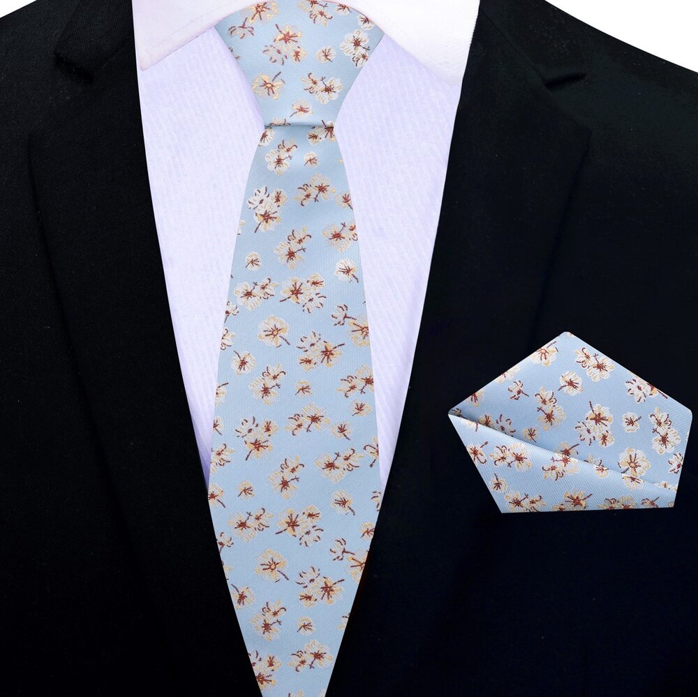 Close-up view of light blue silk floral tie showcasing intricate flower pattern