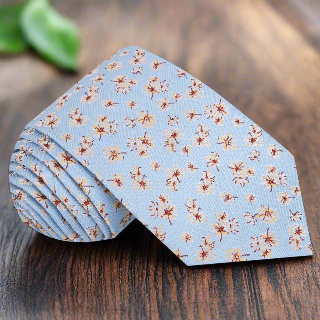 Close-up view of light blue silk floral tie showcasing intricate flower pattern