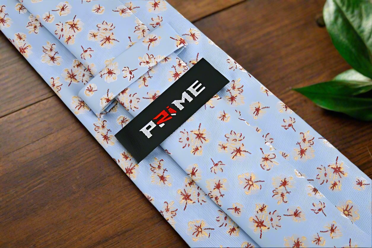 Close-up view of light blue silk floral tie showcasing intricate flower pattern
