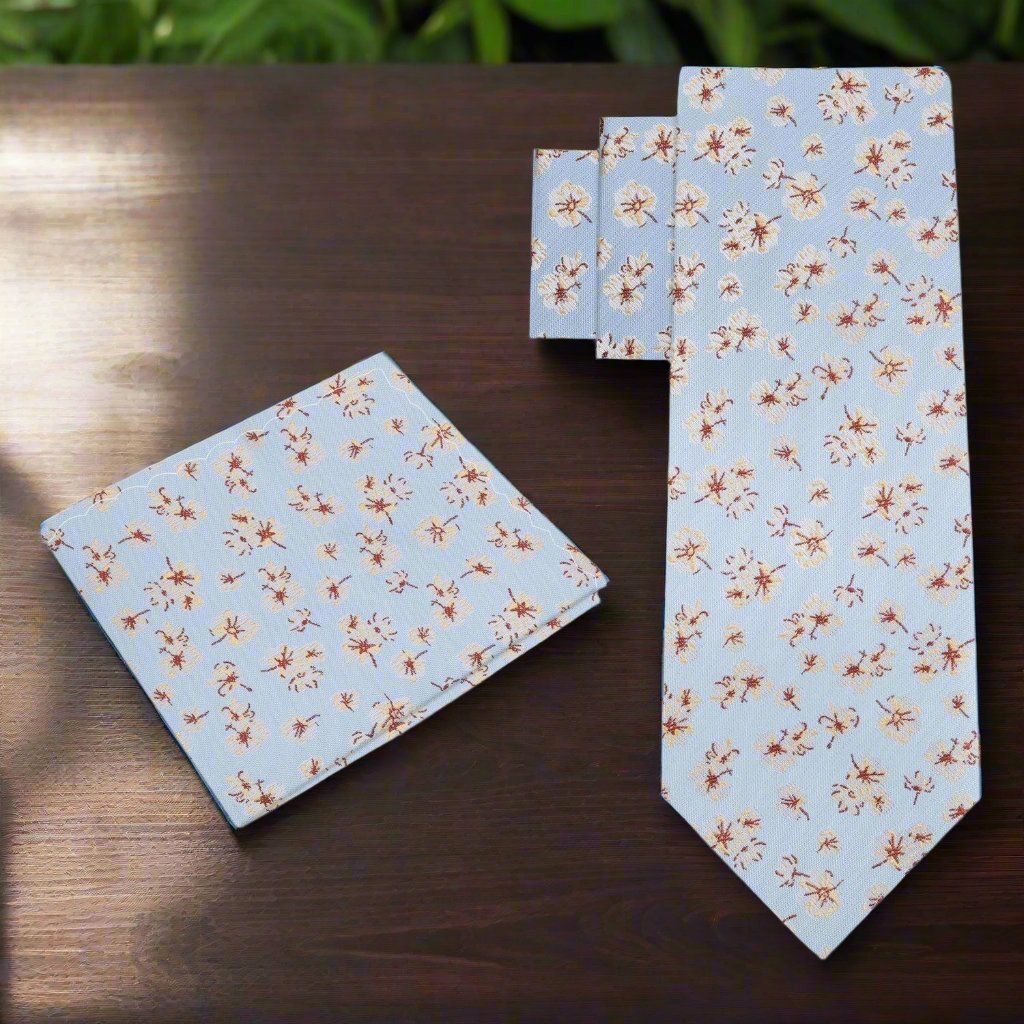 Mens silk tie and pocket square set in light blue with floral accents suitable for business meetings