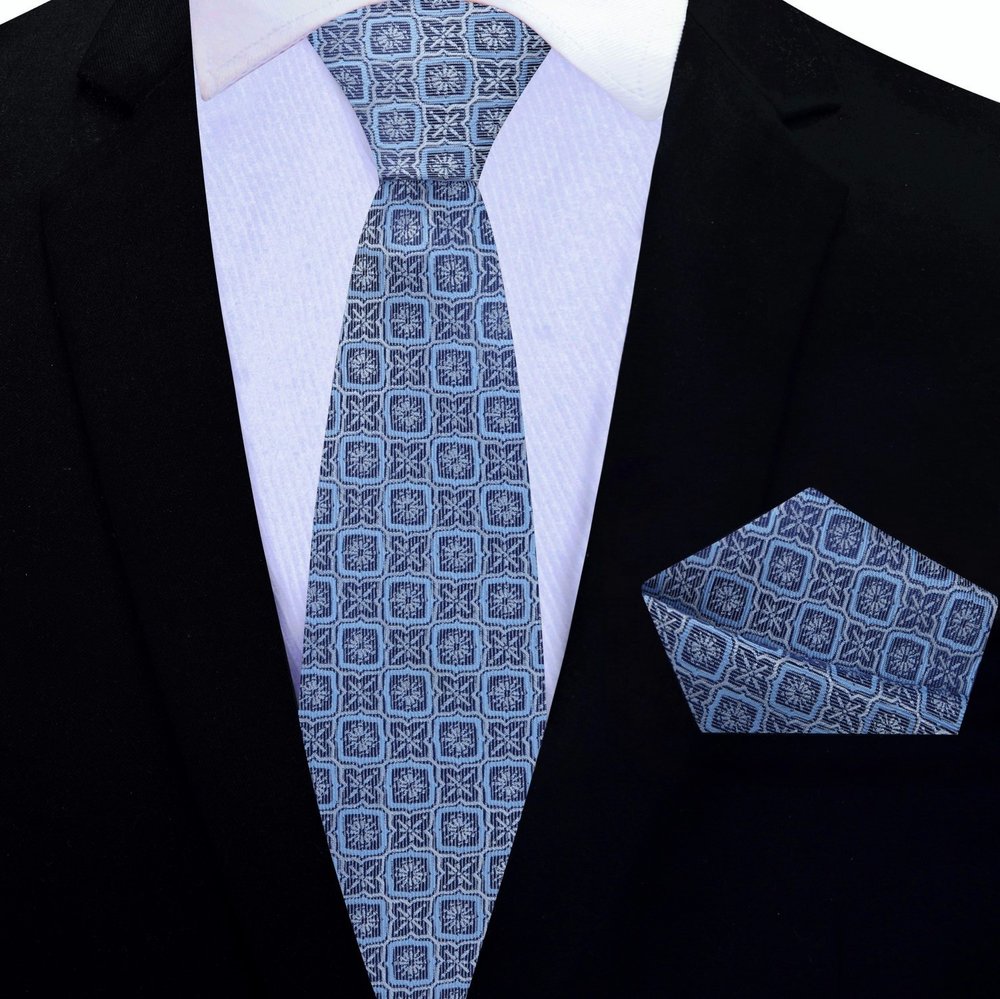 Close-up of geometric pattern silk necktie in peach pink on a display mannequin