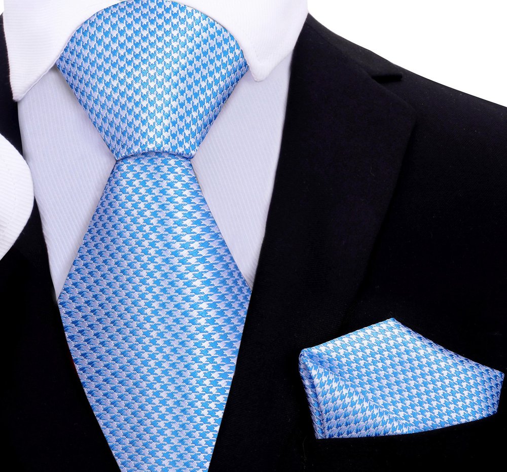 Close-up of metallic gold and black houndstooth silk necktie showcasing intricate pattern