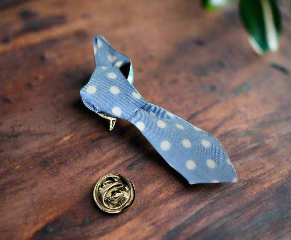 Charming necktie lapel pin displayed on a white dress shirt, showcasing its unique design.