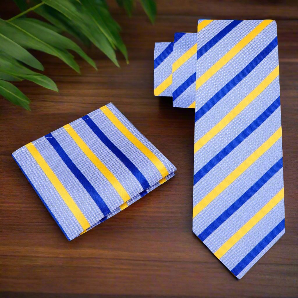 Model wearing a light blue striped necktie at an outdoor summer wedding, accentuating a stylish suit.