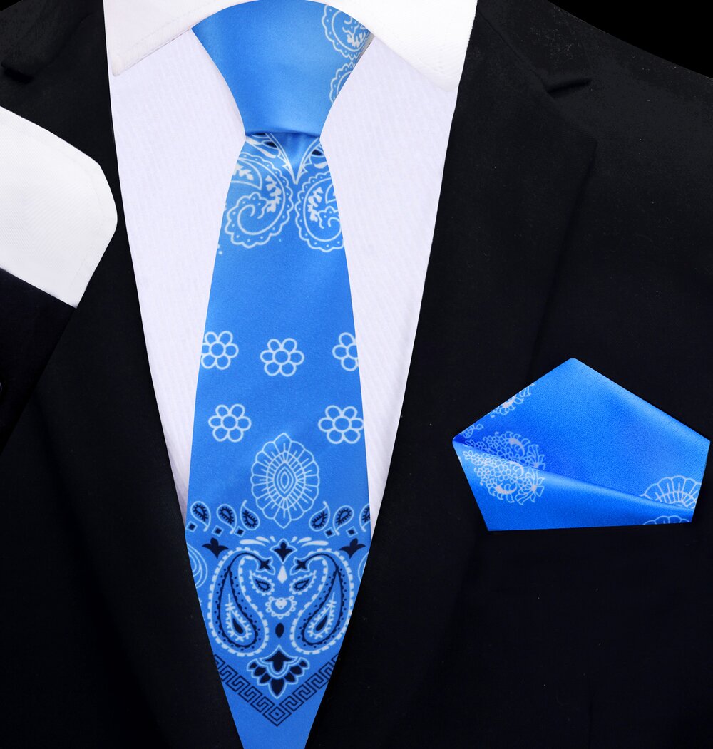 Man wearing a stylish blue paisley tie with a navy suit at a formal event