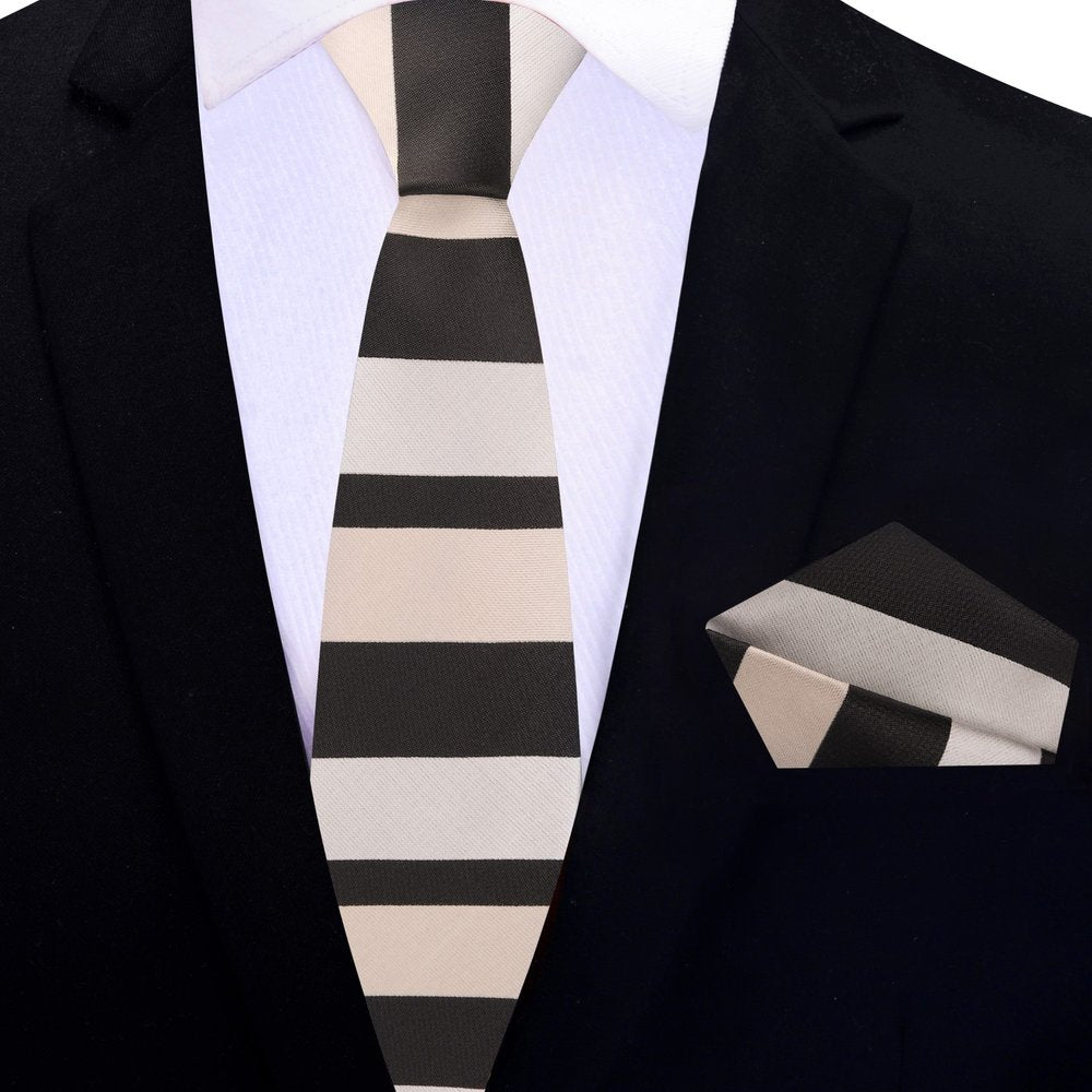 Flat lay of the brown striped silk tie and matching pocket square on a crisp white dress shirt.
