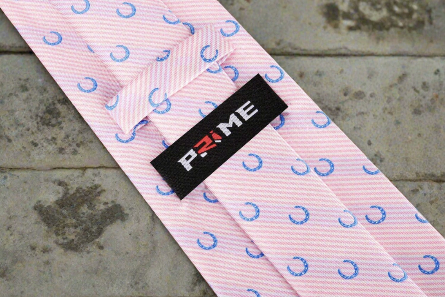 Men wearing silk necktie with horseshoe design at a social event