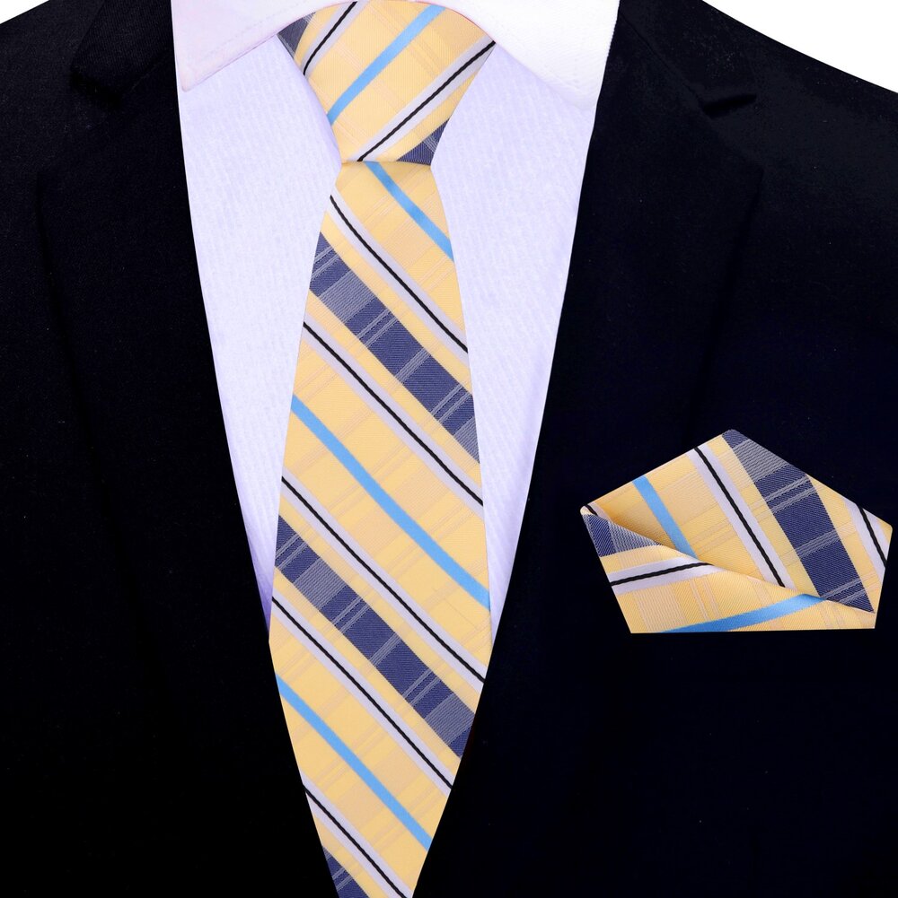 Man wearing a plaid silk necktie with a white dress shirt and navy blazer at a wedding