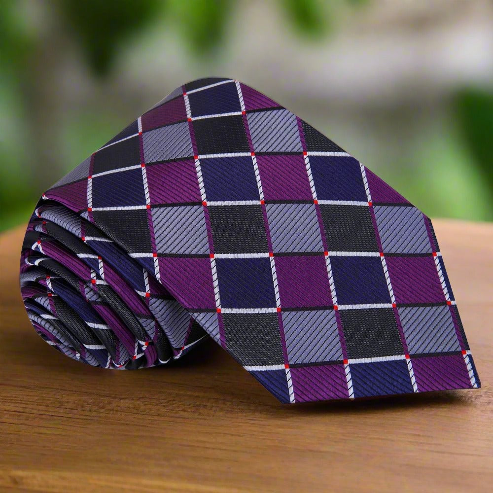 Close-up of a teal and purple geometric silk tie showcasing intricate pattern