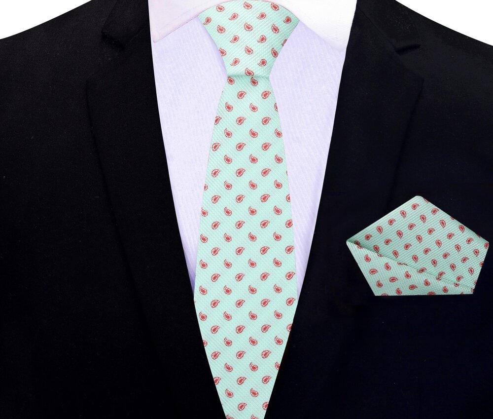 Mint green necktie styled with a navy blue suit for a sophisticated look.