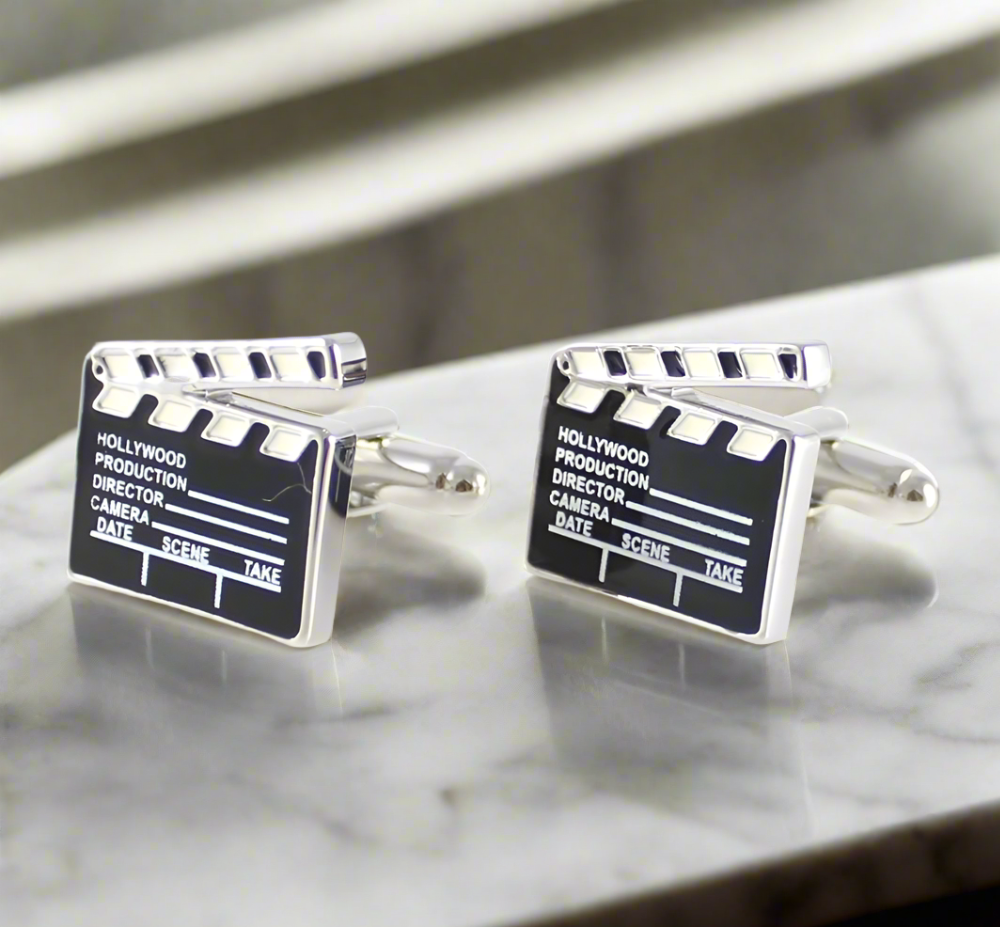 Close-up of director's clapboard cufflinks on a white dress shirt — perfect for film festivals