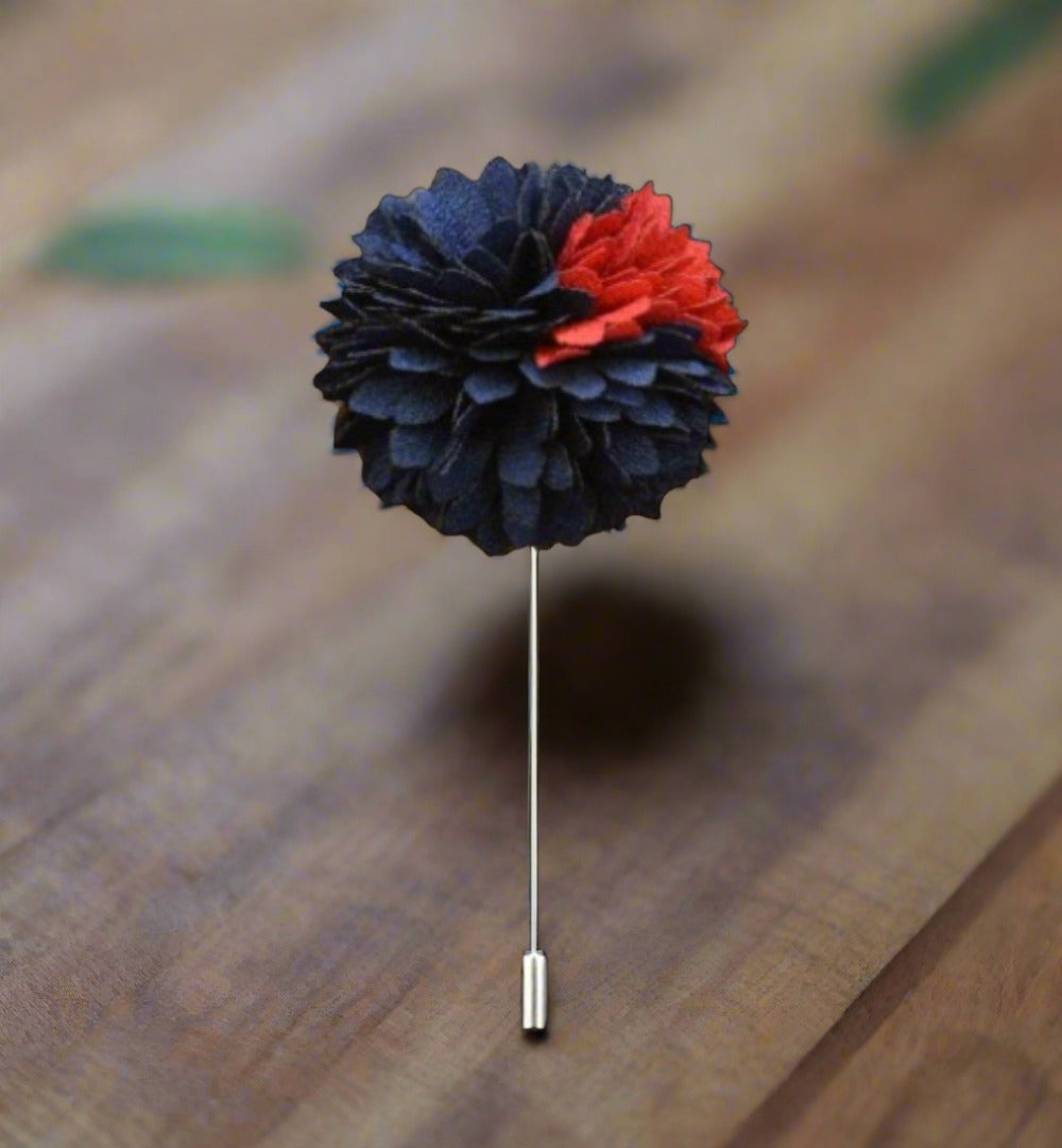 Close-up of mens flower petal lapel pin in red and black, showcasing intricate petal design.