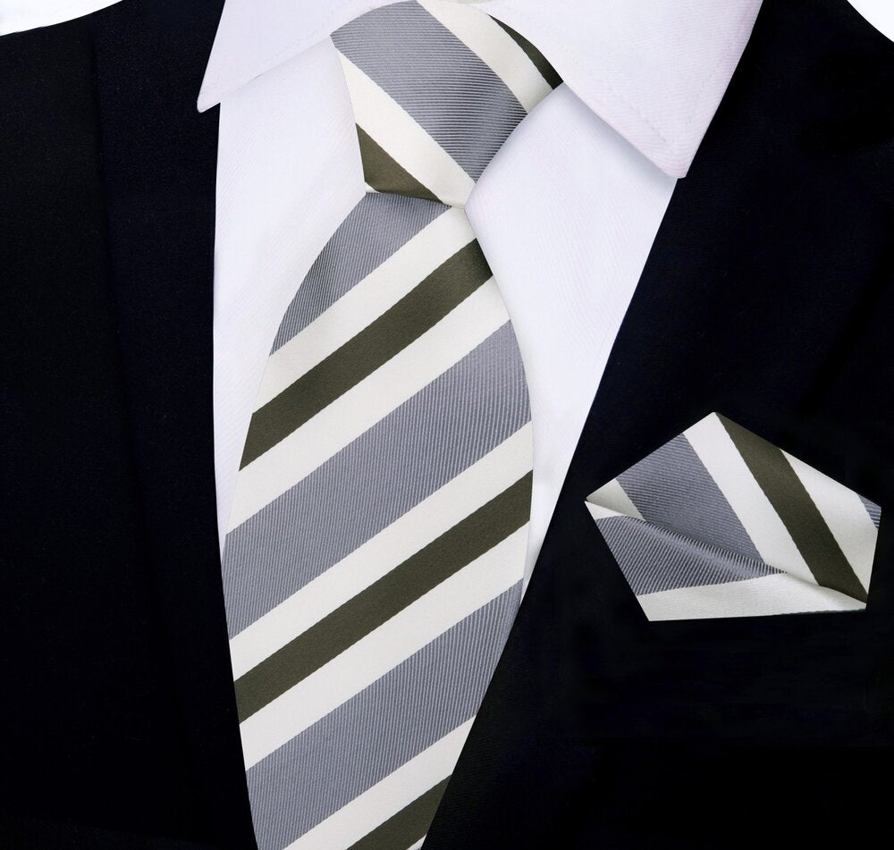 Man wearing a silk necktie and pocket square set with a dark grey suit