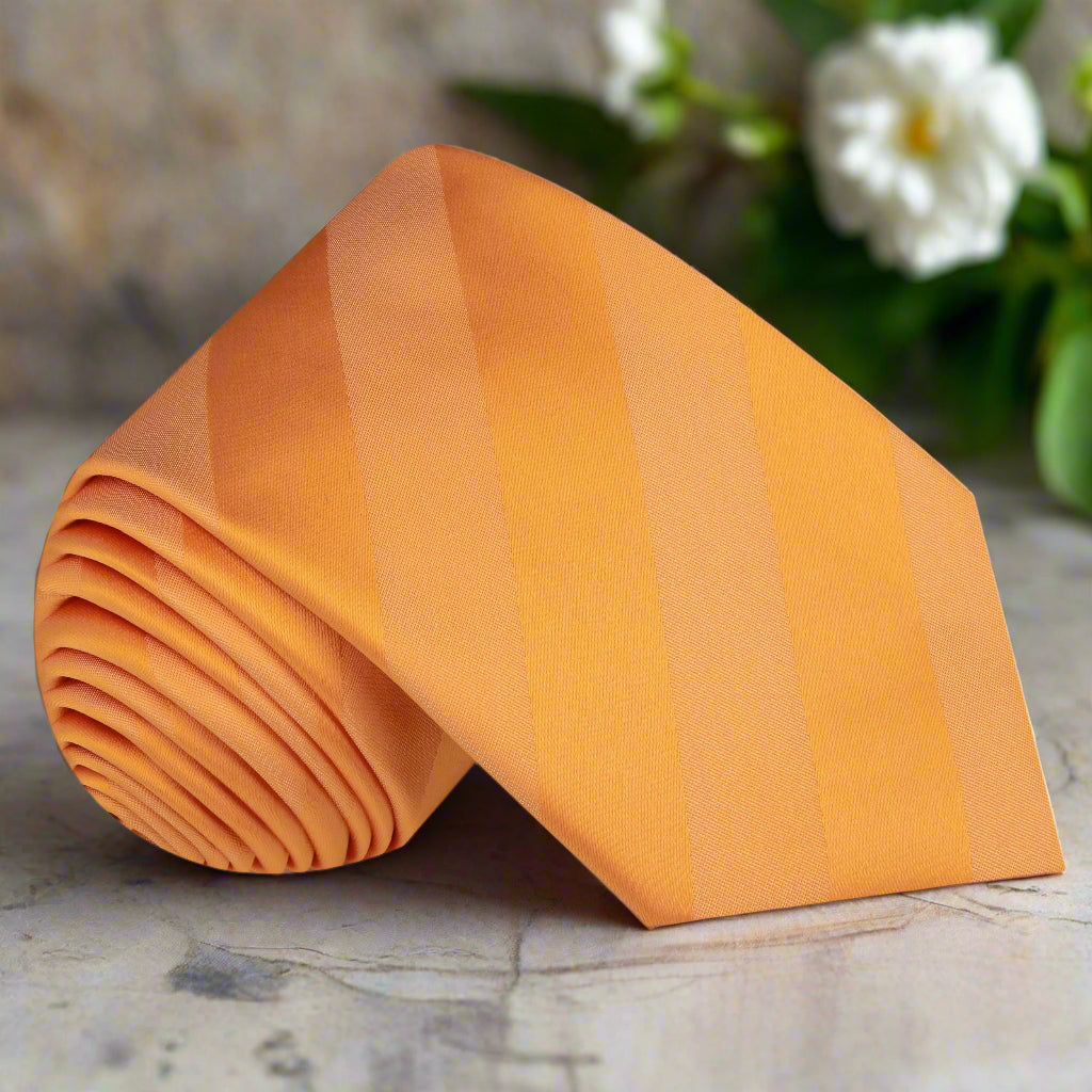 Close-up of vibrant orange silk necktie with stripe pattern for weddings