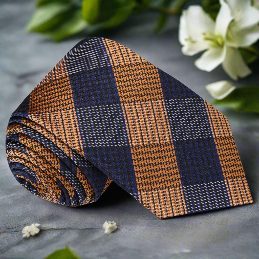 Elegant orange plaid silk necktie displayed on a mannequin for wedding attire