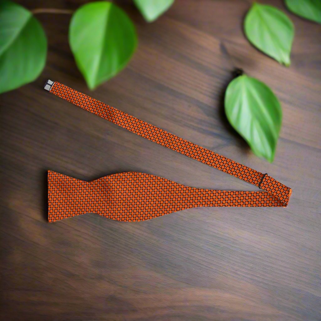 Front view of the copper orange geometric silk bow tie showcasing its intricate pattern.