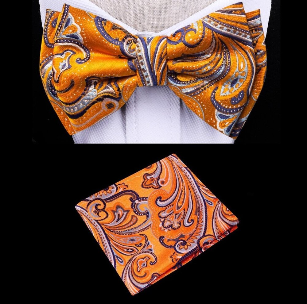 Front view of kids pre-tied bow tie in vibrant orange and paisley pattern